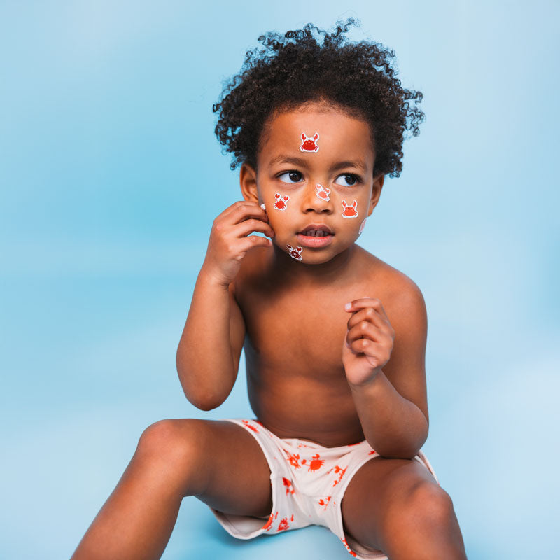 Crabby | beige red UV swimming trunks for boys