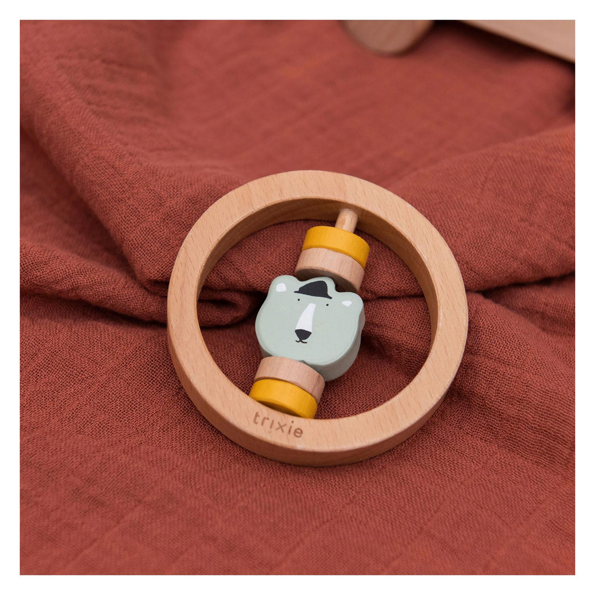 Trixie wooden rattle around Mr. Bear